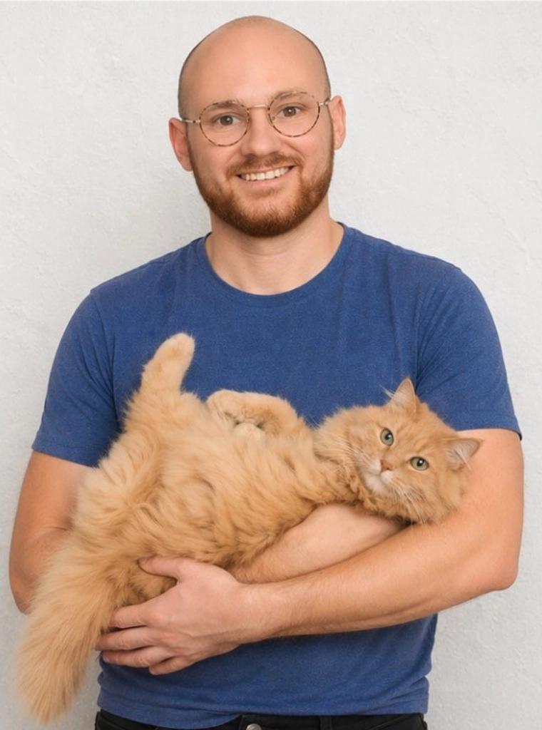 Jonathan Young, founder of PlutoRx, holding an orange cat